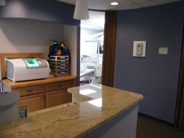 The end of the granite front desk, with the corridor to the treatment rooms beyond.